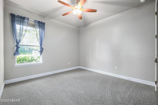 unfurnished room featuring ceiling fan, carpet, and baseboards