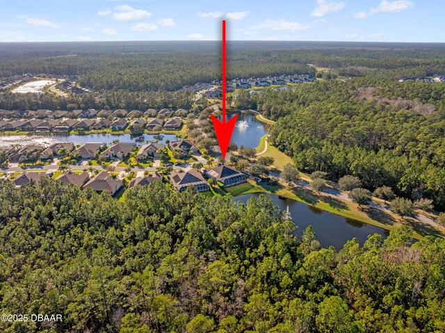 birds eye view of property featuring a water view, a forest view, and a residential view