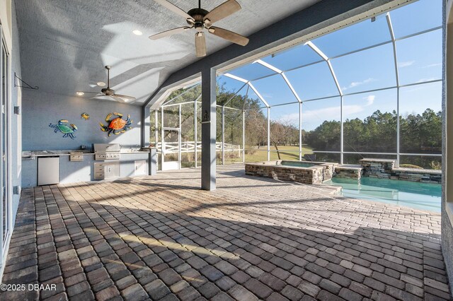 view of patio / terrace featuring exterior kitchen, a lanai, and a pool with connected hot tub