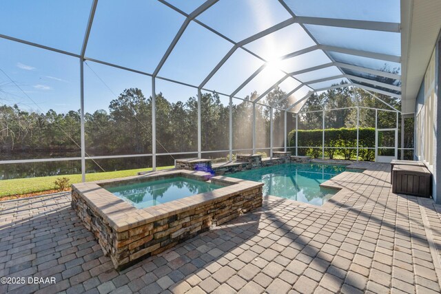 view of swimming pool featuring a lanai, a patio area, and a pool with connected hot tub