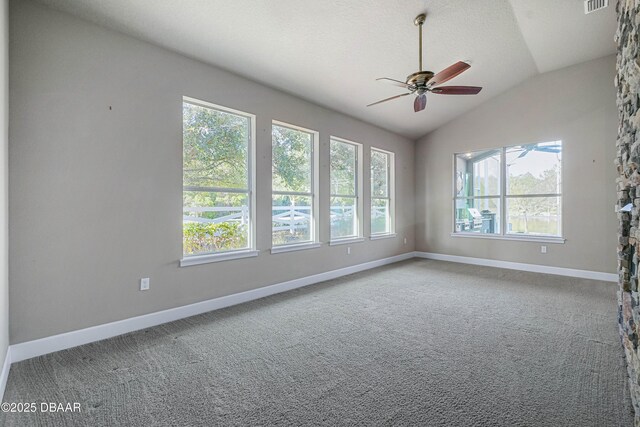 unfurnished room with visible vents, baseboards, a ceiling fan, lofted ceiling, and carpet