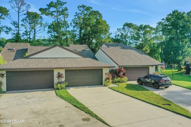 view of front of property with a garage and a front lawn