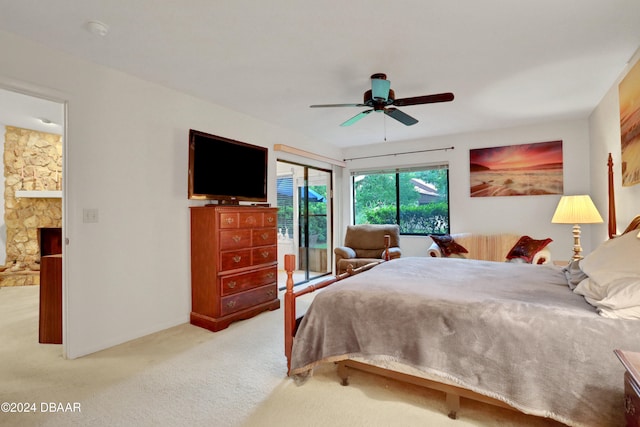 carpeted bedroom with ceiling fan and ensuite bathroom