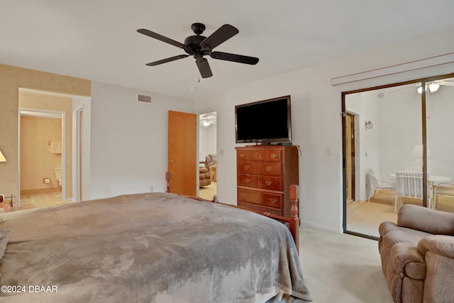 carpeted bedroom with connected bathroom and ceiling fan