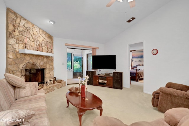 carpeted living room featuring a stone fireplace, ceiling fan, and high vaulted ceiling