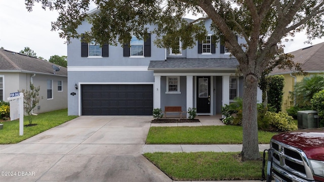 view of front of house with a front lawn and a garage