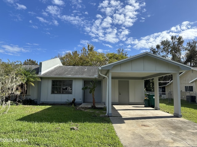 ranch-style house with a carport, central AC unit, and a front lawn