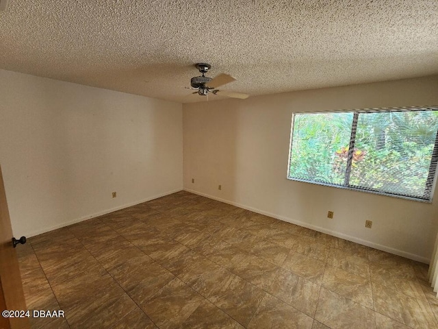 unfurnished room with a textured ceiling and ceiling fan