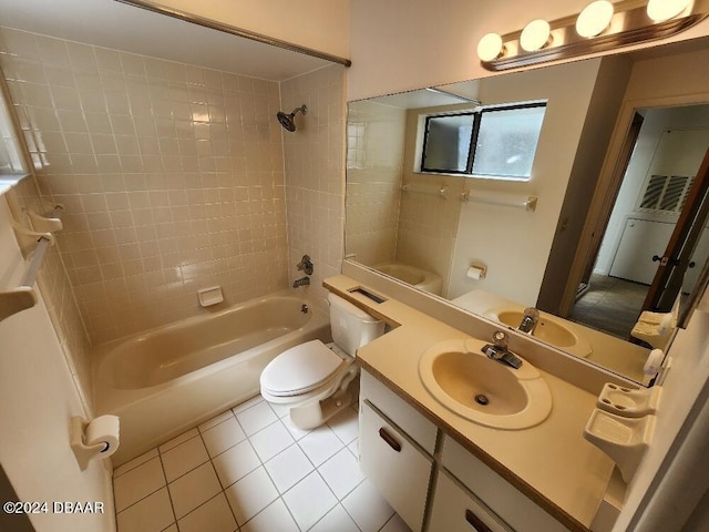 full bathroom with toilet, vanity, tiled shower / bath, and tile patterned flooring