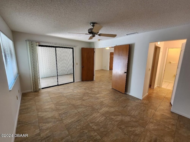 unfurnished bedroom featuring a textured ceiling and ceiling fan