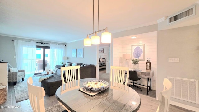 1275 Ocean Shore Blvd Unit 206, Ormond Beach, FL 32176 - dining area featuring crown molding and light wood finished floors