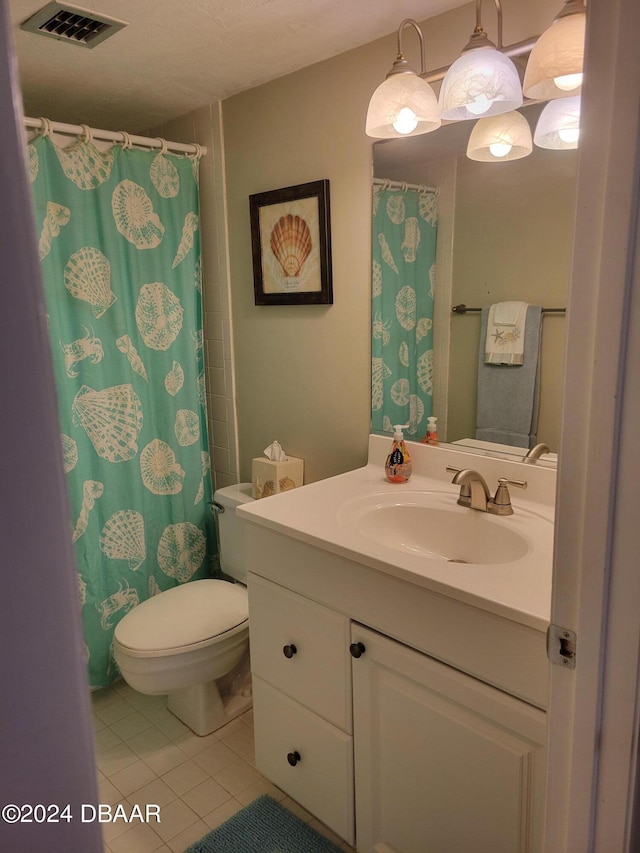 bathroom featuring tile patterned flooring, vanity, curtained shower, and toilet