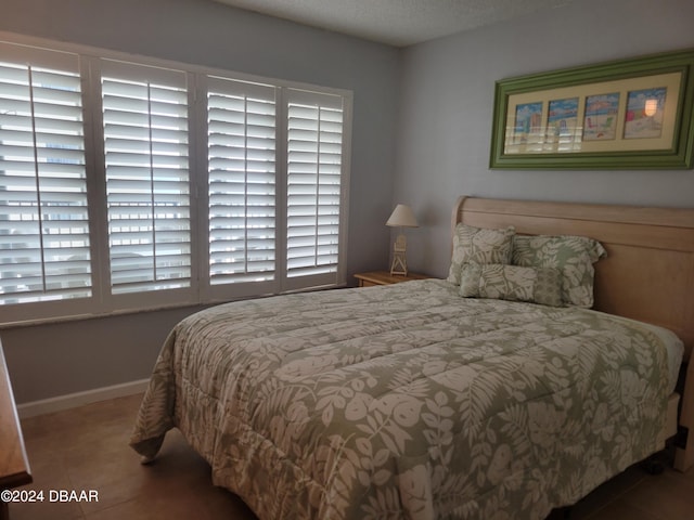 tiled bedroom featuring multiple windows