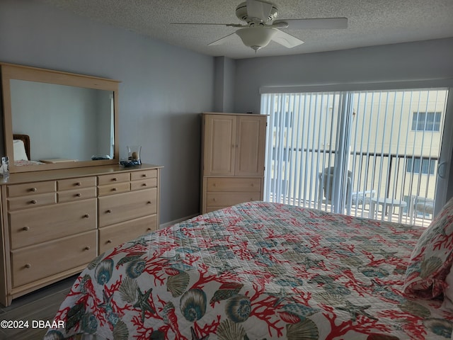 bedroom featuring ceiling fan, access to exterior, and a textured ceiling