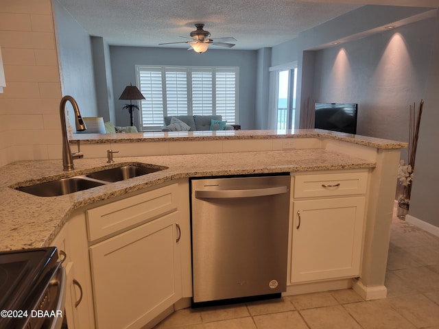 kitchen featuring light stone counters, sink, white cabinets, and dishwasher