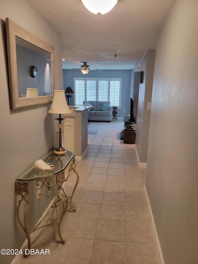 corridor featuring light tile patterned floors