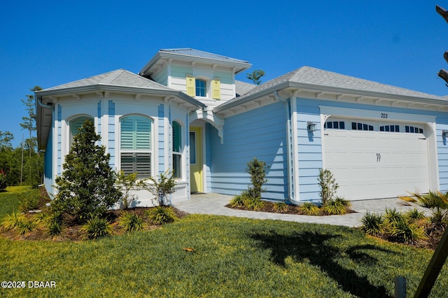 703 Coral Reef Way, Daytona Beach, FL 32124 - italianate-style house with an attached garage and a front yard