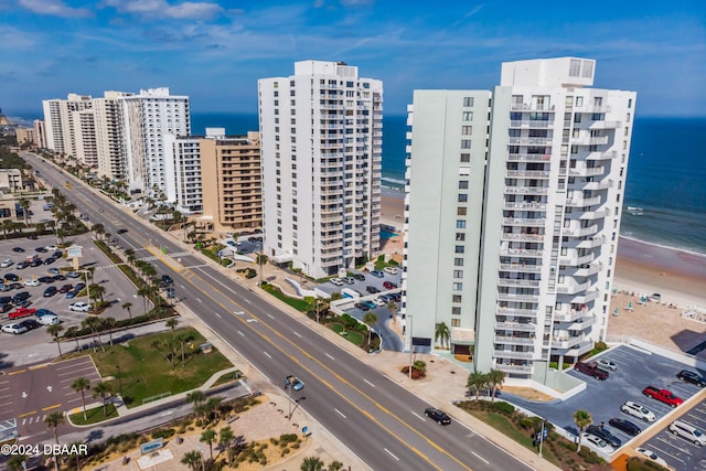 drone / aerial view featuring a water view and a view of the beach