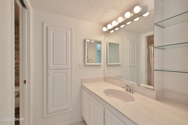 bathroom with vanity and a textured ceiling