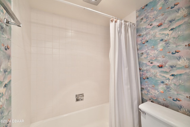 bathroom featuring shower / bath combo and toilet