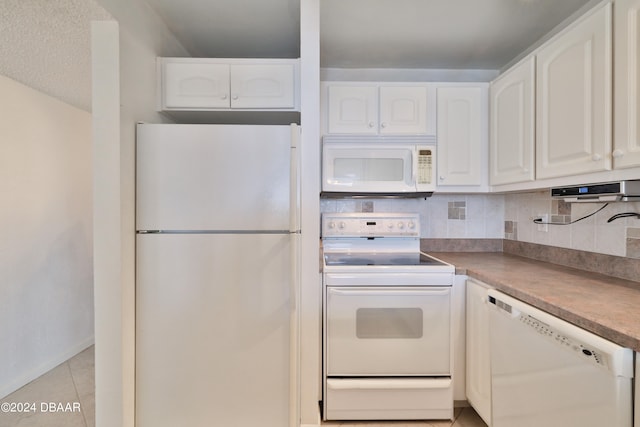 kitchen featuring white cabinets, white appliances, light tile patterned floors, and backsplash