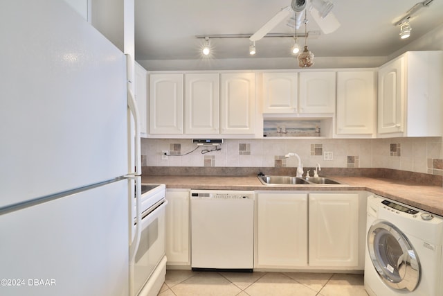 kitchen featuring white cabinetry, light tile patterned floors, washer / clothes dryer, sink, and white appliances