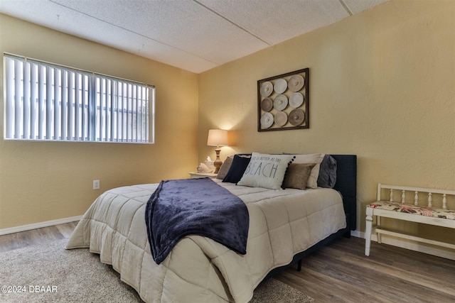 bedroom with wood-type flooring and a textured ceiling