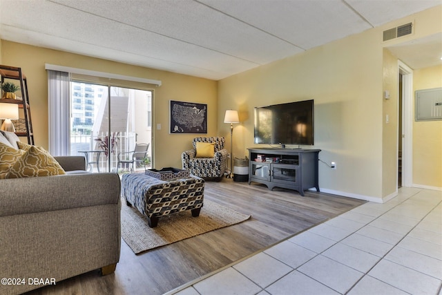 living room featuring a textured ceiling and light hardwood / wood-style floors