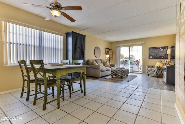 dining area featuring a textured ceiling, light wood-type flooring, and ceiling fan