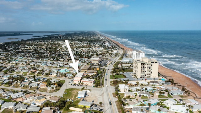 birds eye view of property with a beach view and a water view