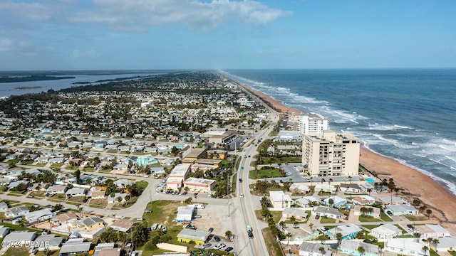 birds eye view of property with a view of the beach and a water view