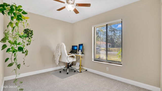 carpeted home office featuring a healthy amount of sunlight and ceiling fan