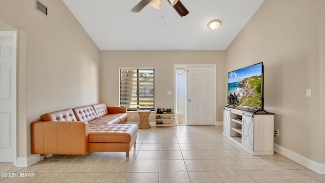 living room with ceiling fan, vaulted ceiling, and light tile patterned floors