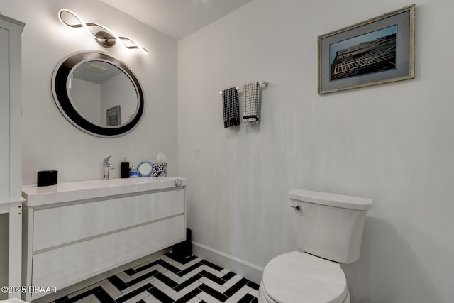 bathroom featuring vanity and toilet