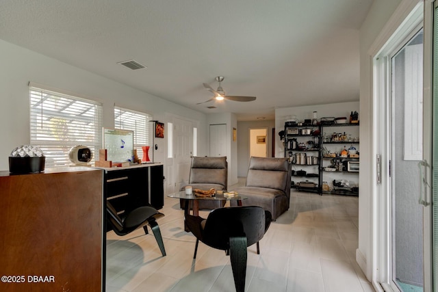 sitting room with ceiling fan