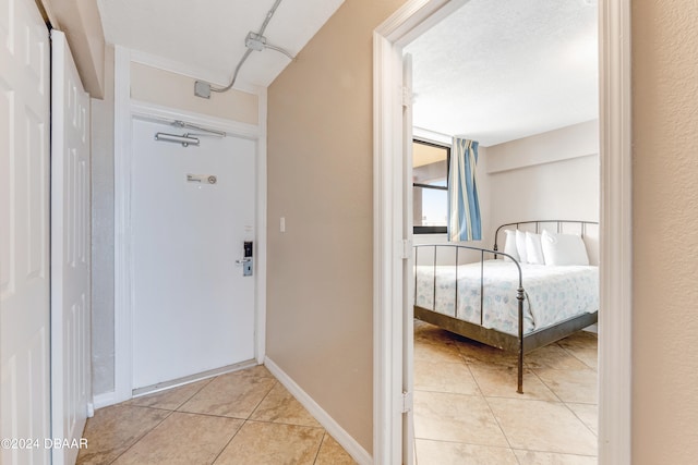 hall featuring light tile patterned floors