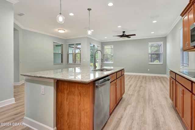 kitchen featuring a healthy amount of sunlight, stainless steel appliances, ceiling fan, and a center island with sink