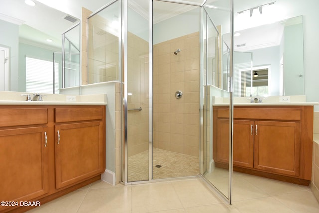 bathroom featuring tile patterned floors, vanity, a shower with shower door, and ornamental molding