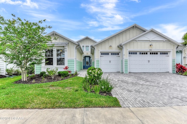 view of front of property with a garage and a front lawn