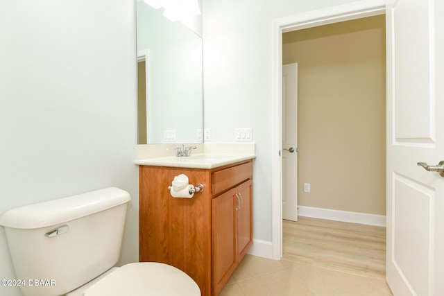 bathroom featuring hardwood / wood-style floors, vanity, and toilet