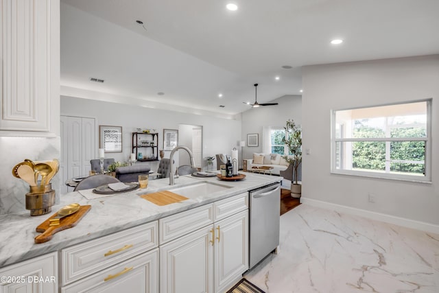 620 Middlebury Loop, New Smyrna Beach, FL 32168 - kitchen featuring dishwasher, open floor plan, recessed lighting, light marble finish floors, and white cabinetry