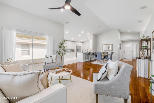 620 Middlebury Loop, New Smyrna Beach, FL 32168 - living area with lofted ceiling, a ceiling fan, wood finished floors, and recessed lighting