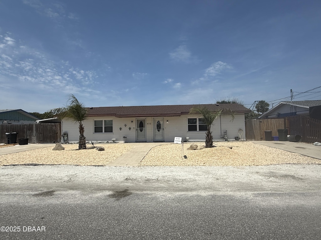 ranch-style home with fence