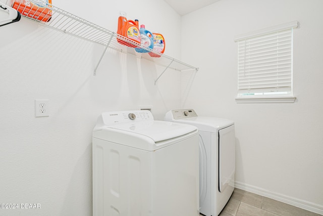 laundry area featuring separate washer and dryer and light tile patterned floors