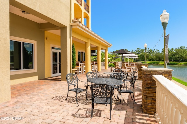 view of patio with a water view