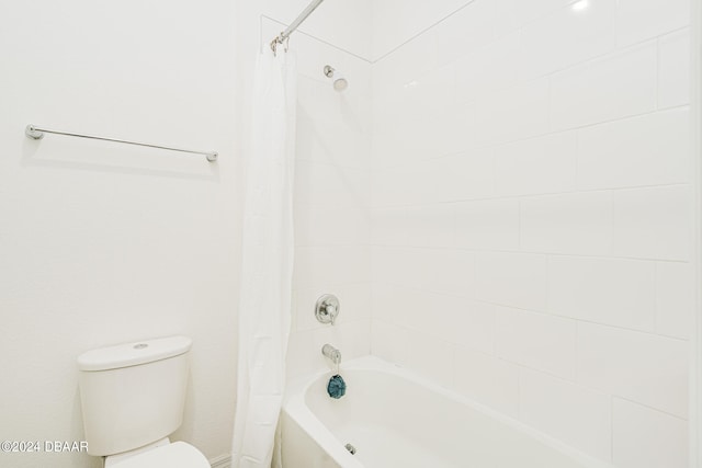 bathroom with shower / bath combination with curtain and toilet