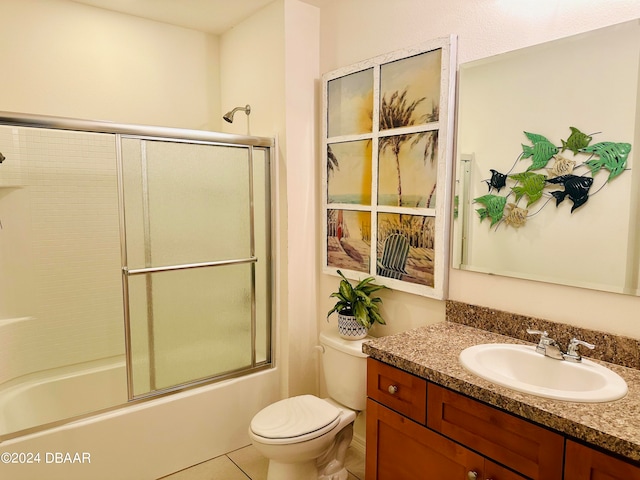 full bathroom with toilet, vanity, tile patterned flooring, and enclosed tub / shower combo