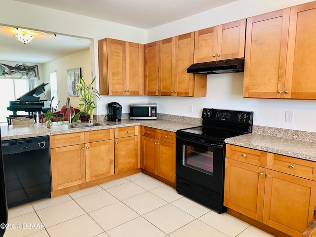 kitchen with black appliances, sink, and light tile patterned flooring