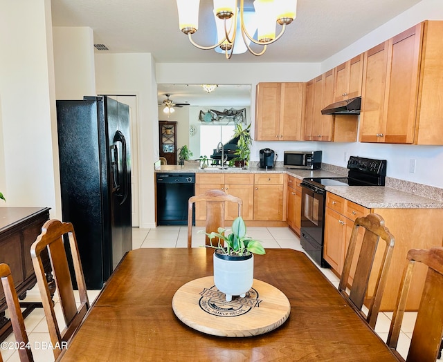 kitchen featuring black appliances, light tile patterned floors, pendant lighting, sink, and ceiling fan with notable chandelier