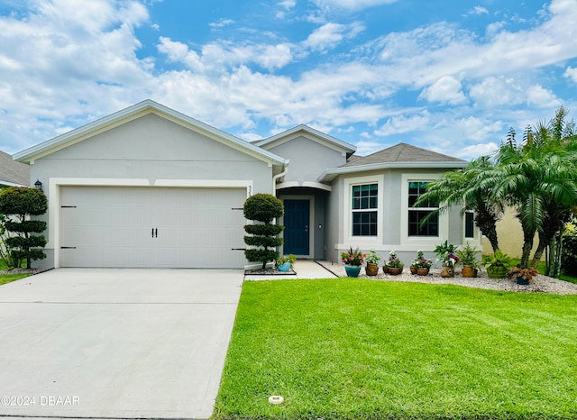 single story home featuring a front lawn and a garage